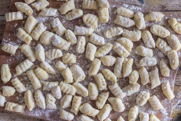 Homemade Gnocchi resting for 20 minutes on a wooden board